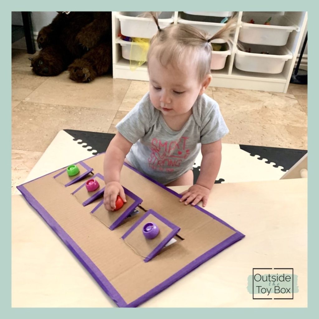 Baby playing with DIY Cardboard lift flap toy