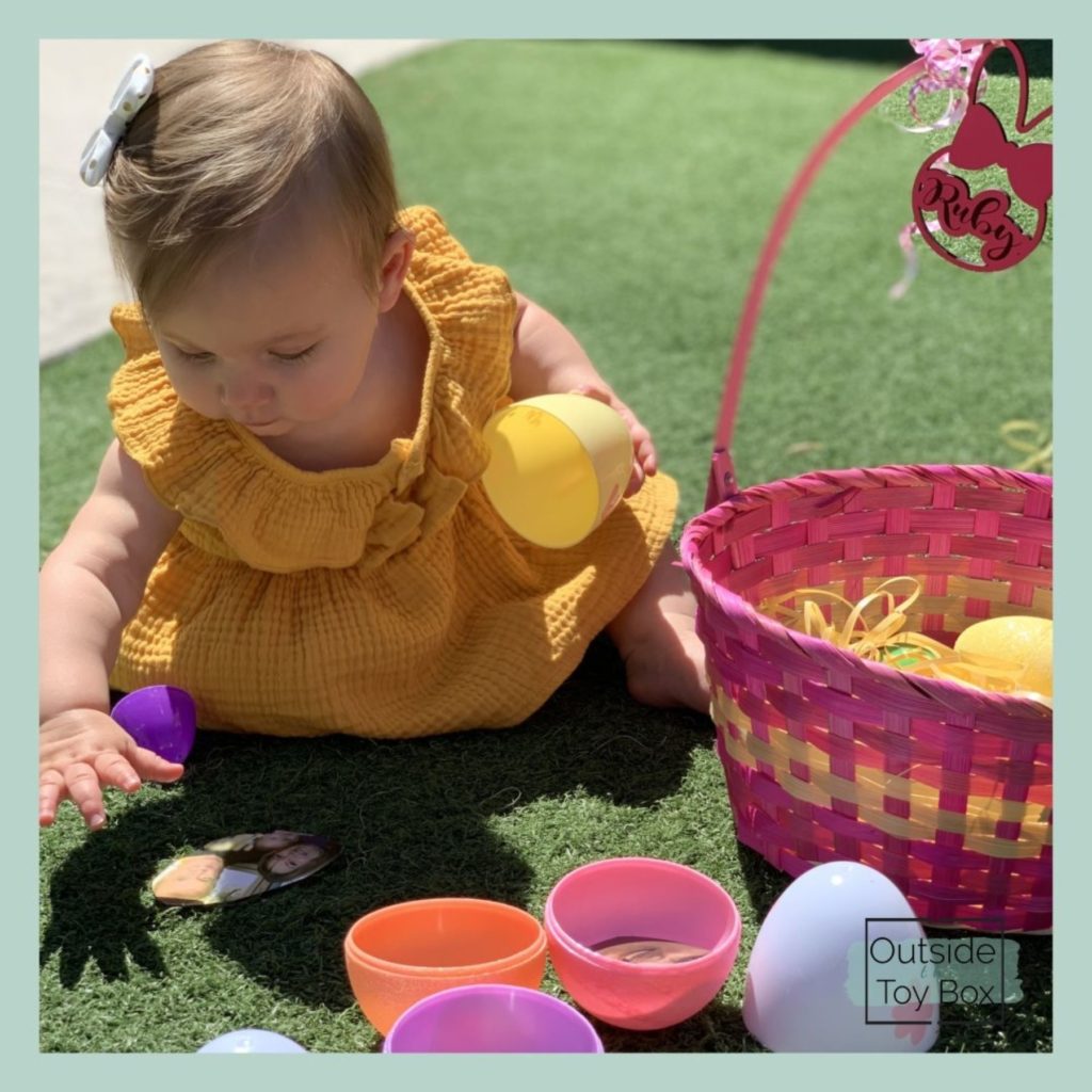 Baby reaching for picture hidden in Easter egg
