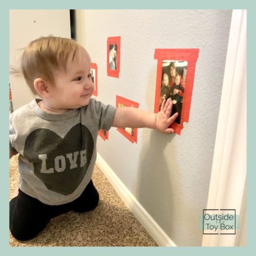 Baby looking at picture hung at eye level
