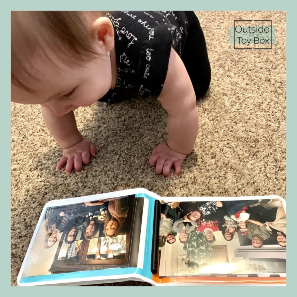 Baby looking at photo album