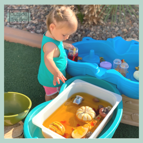 Toddler playing at a Fall themed water table