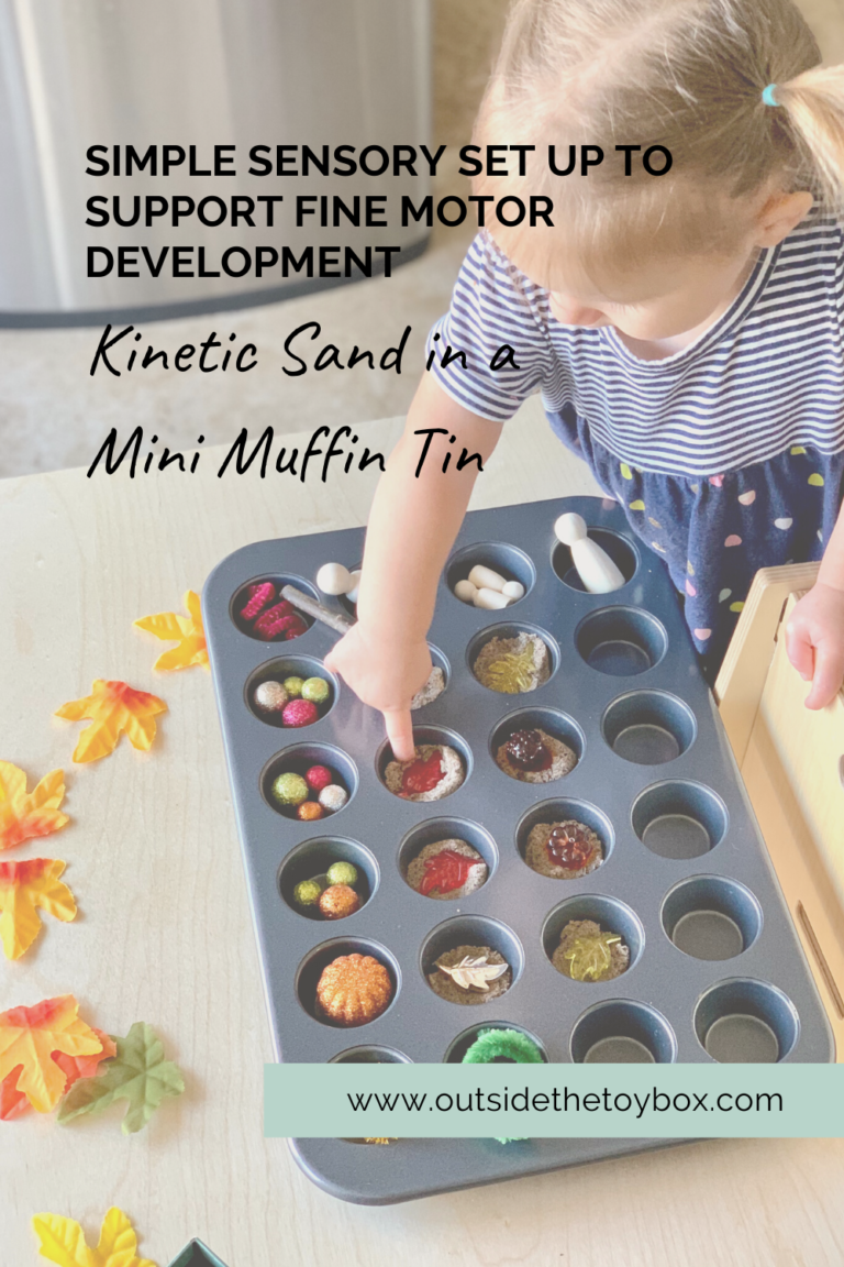 Toddler playing with kinetic sand in mini muffin tin