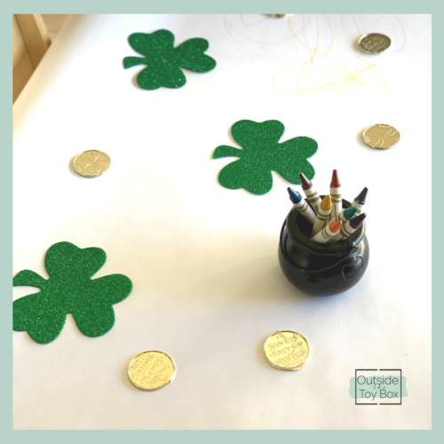 Gold coins and shamrocks on paper with crayons