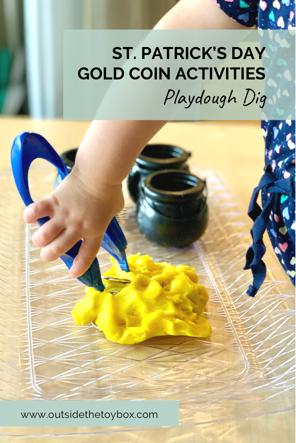 toddler using tweezers to pull gold coins from play dough