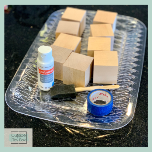 wooden blocks with white paint, foam paintbrush, and tape