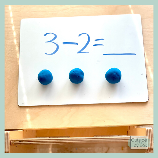 Subtraction problem with balls of play dough