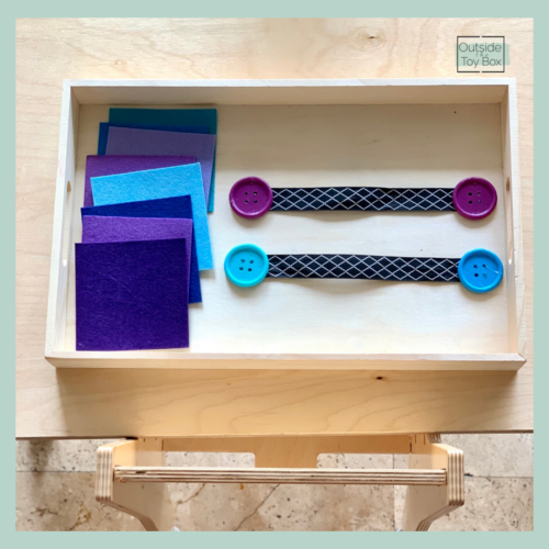 Buttoning skills DIY activity blue and purple felt with blue and purple buttons on ribbon