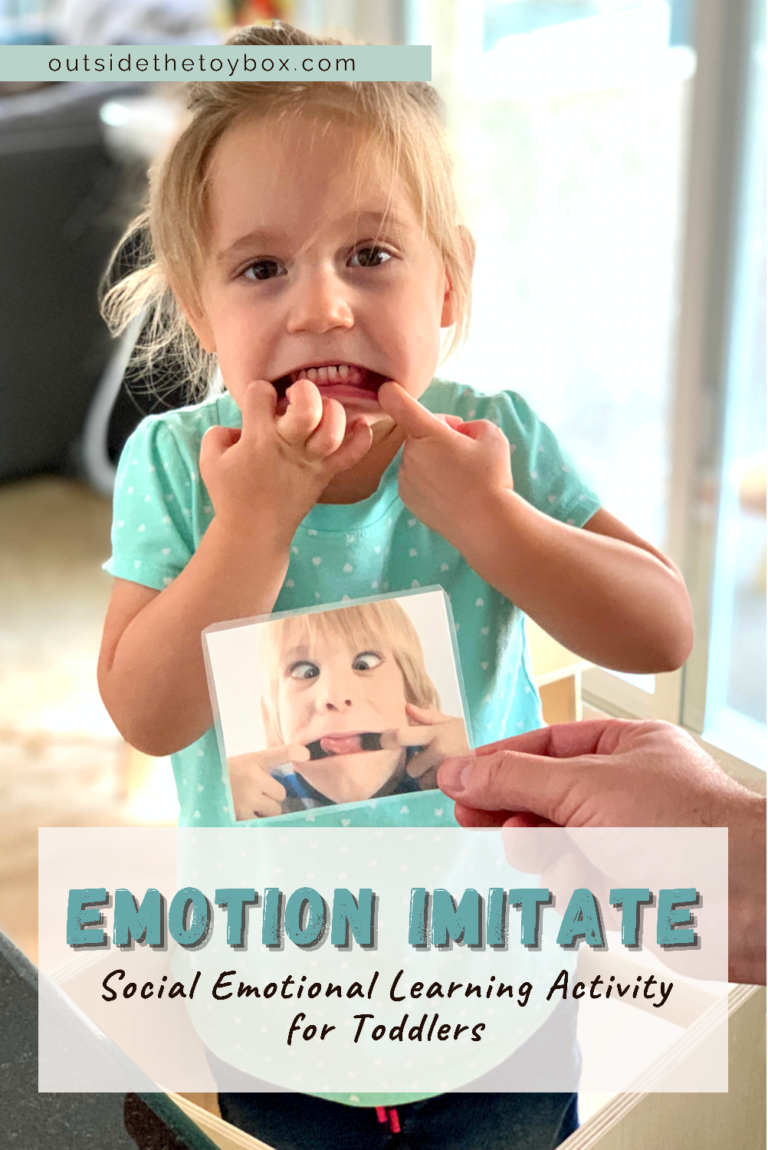 Toddler imitating silly face on card